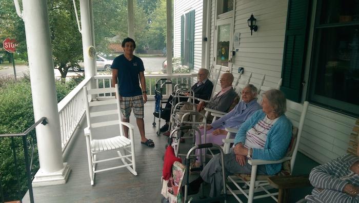 Residents of The Dixon House are thankful to Justin Le (standing) for completing his Eagle Service Project by refurbishing the classic white wood rockers. Seated are Milton Agreen, George Irwin, Katherine Emerson and Carol Lafleur. 