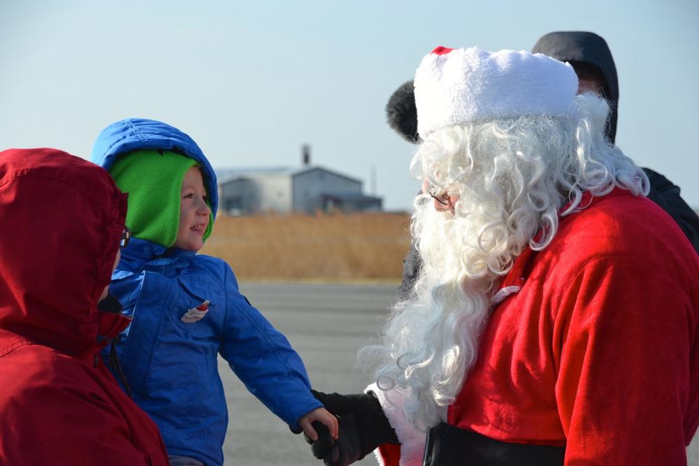 child greets Santa