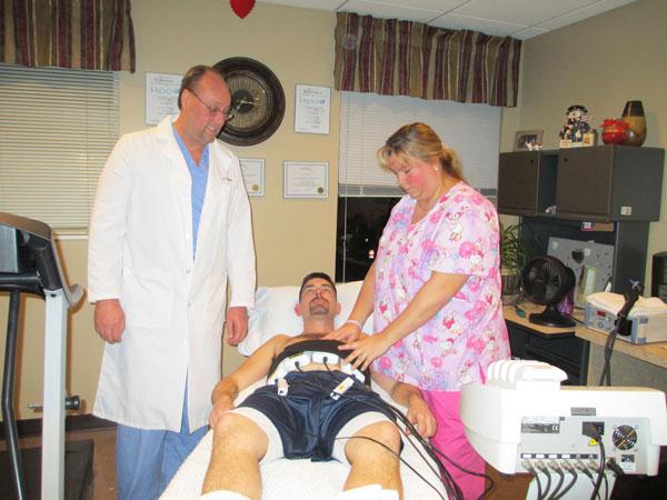 Dr. Callahan demonstrates an i-Lipo treatment on patient Adrian Nicholson at The Chesapeake Center for Pain and Balance. After just one i-Lipo session, Nicholson lost 3/4” from around his abdomen.