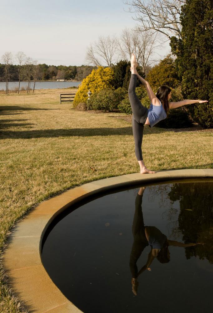 Pictured is Elizabeth Gonzalez, B.S., M.S.Ed, owner and director of Bikram Yoga Eastern Shore doing a yoga pose.