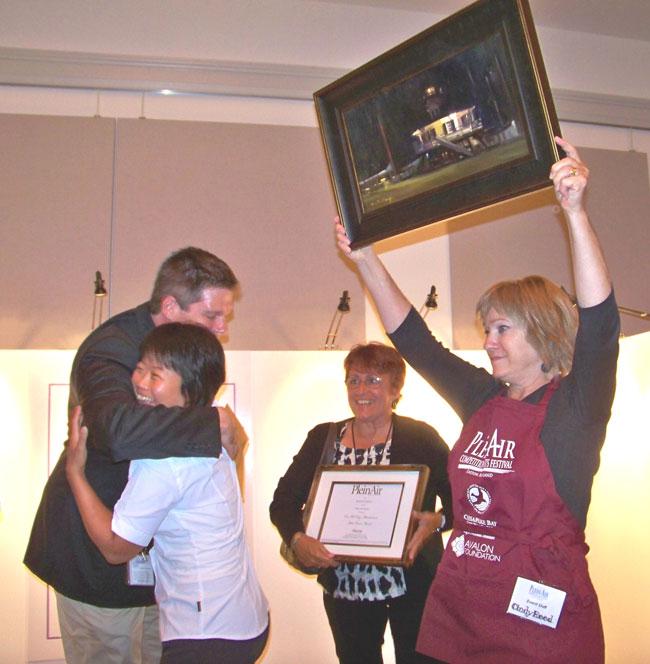 Hiu Lai Chong from Rockville MD is congratulated by Al Bond of the Avalon Foundation and Krystal Allen of PleinAir magazine. Chong’s “All Tucked In” was the winner of the 2012 Plein Air–Easton! Grand Prize Timothy E. Dills Memorial Award. The painting also received the Artists’ Choice Award. Chong returns to vie against 57 other artists for $20,000 in prizes during the 9th Annual Plein Air–Easton! Competition & Arts Festival, to be held July 15-21, 2013.   photo by Chris Polk, courtesy of the Star Democrat