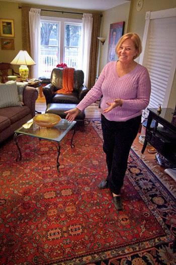 Easton resident Marge Coyman shows off the Oriental rug she bought at ReStore.  The windows behind her came from ReStore too.