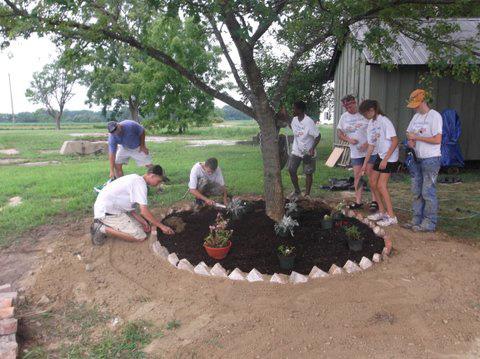 Trappe Summer Youth Program participants (left to right) Chris Lednum, Doug McGarry, John McGarry, Brian Watson, Kathy Kemp, supervisor, Caley Christopher, and Emily Baynard plant a new garden. 
