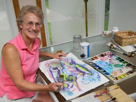 Joan Cranor at work on a new watercolor.