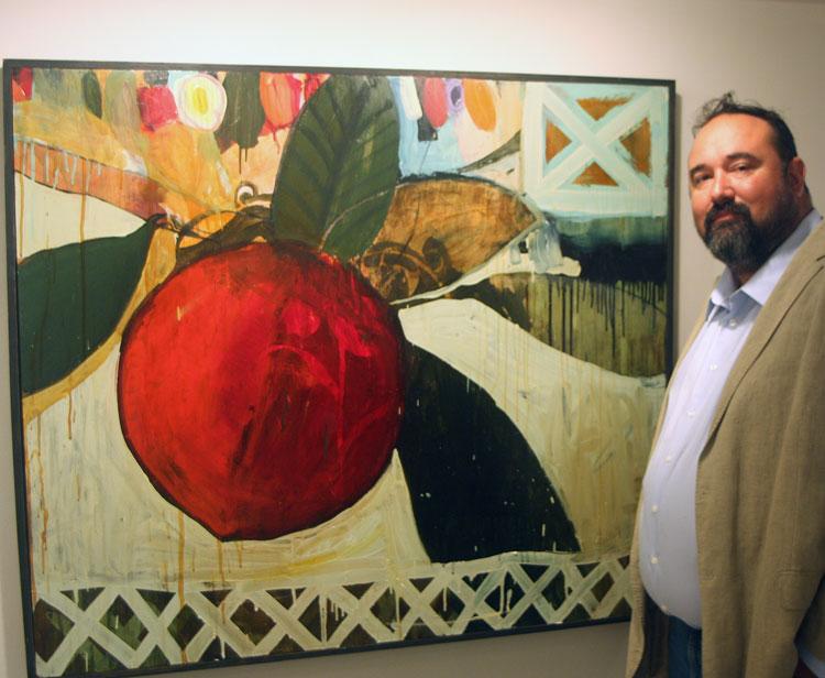 Joe Karlik, next to one his his paintings at the Carla Massoni Gallery on High St. The show will remain throughout the month.