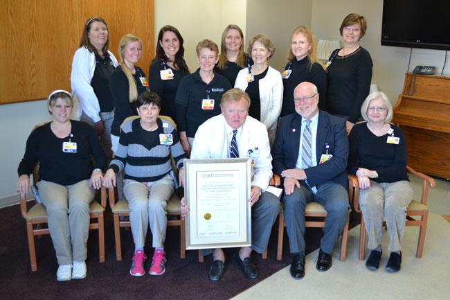 Shown with their CARF certificate are Requard team members (front row) Shawne Davis, RN, Sherry Dolby, RN-BC, Manager, Stephen Wills, MD, Medical Director; Bill Roth, Senior Director, Comprehensive Rehabilitation Services and Deborah Medford, RN-BC;  and (back row) Sara Pender, MS, OTR/L, Jessica Denny, PT, DPT, Margaret Wood, PT, MPT, DeDee Cole, PTA, Maryanne Williams Rehab Aide/Education Assistant, Cassandra Kinser, MS, OTR/L, and Teresa Blem, PT, Director of Rehabilitation Services. 