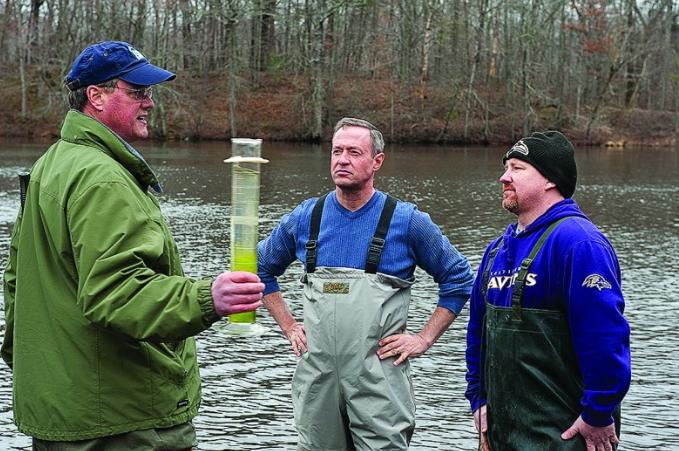 n this photo from 2011, former MDE Secretary Robert Summers holds a sample of water from Lake Bonnie as former Gov. Martin O’Malley, center, and the lake’s new owner, Johnathan Merson, look on. The lake has been closed to swimming for 17 years because of contamination from failing septic systems in the nearby town of Goldsboro. (Jay L. Baker /Governor’s Press Office)